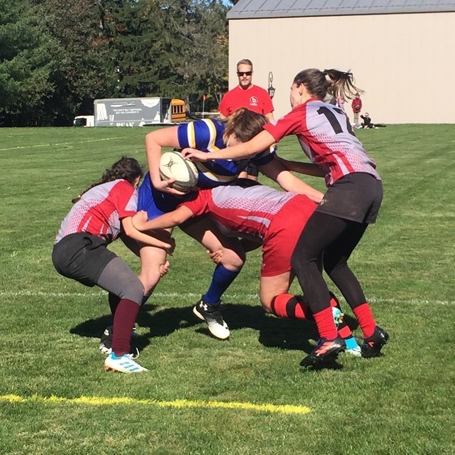 Women's rugby players going for a tackle