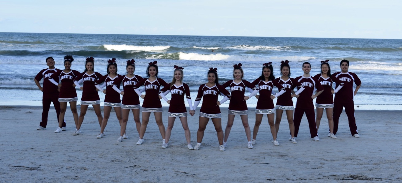 Cheerleaders posing on beach