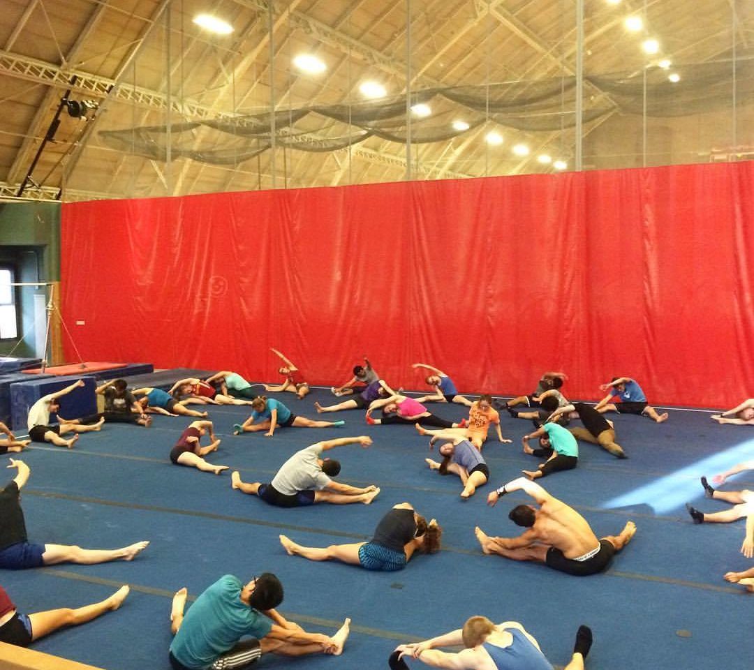 Gymnasts stretching on mat