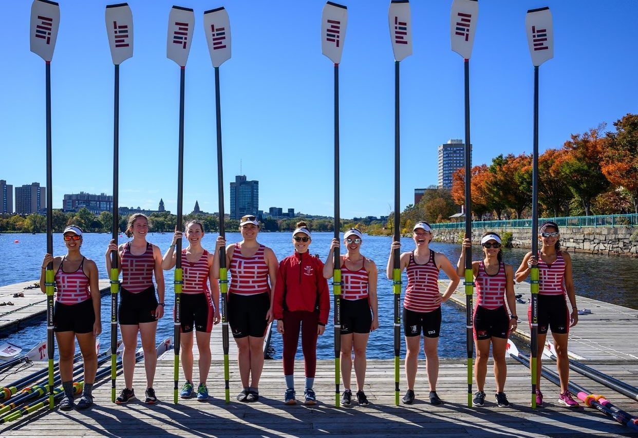 Rowers with oars posed on dock