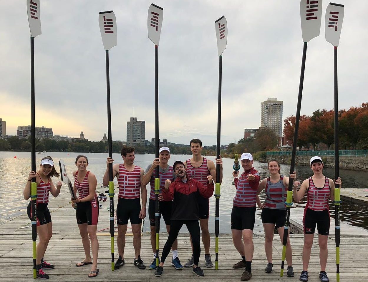 Rowers with oars posed on dock