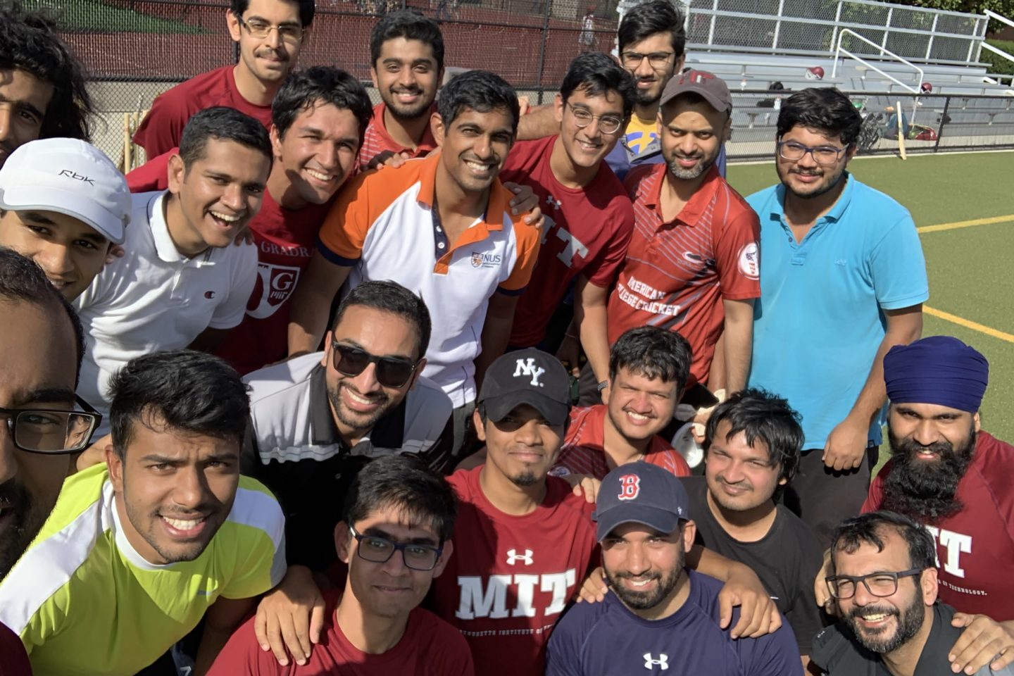 Cricket students posing with alumni at alumni game