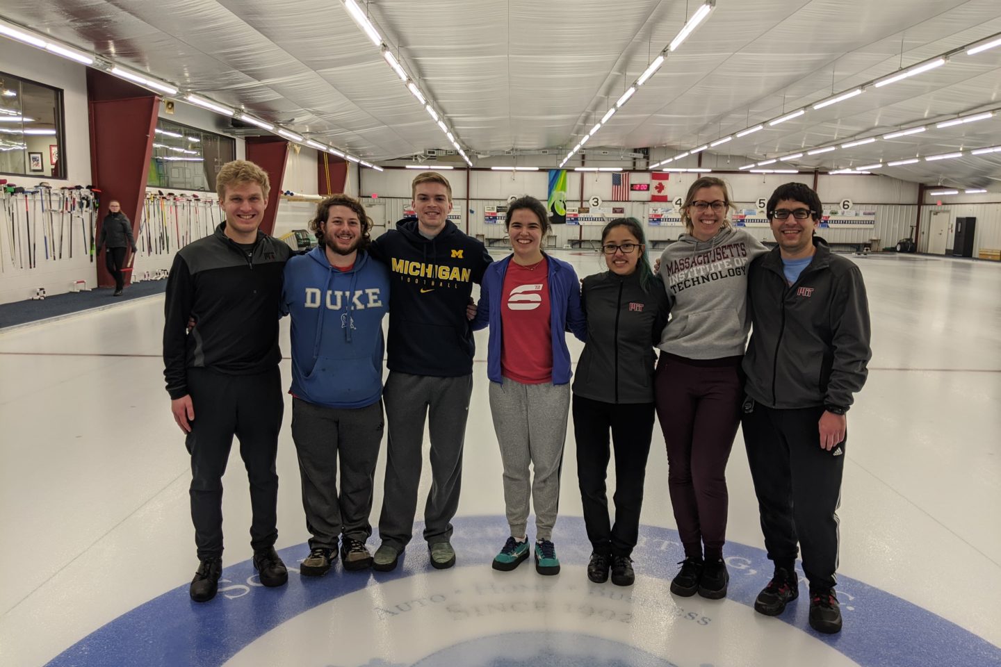 Curling students standing on ice